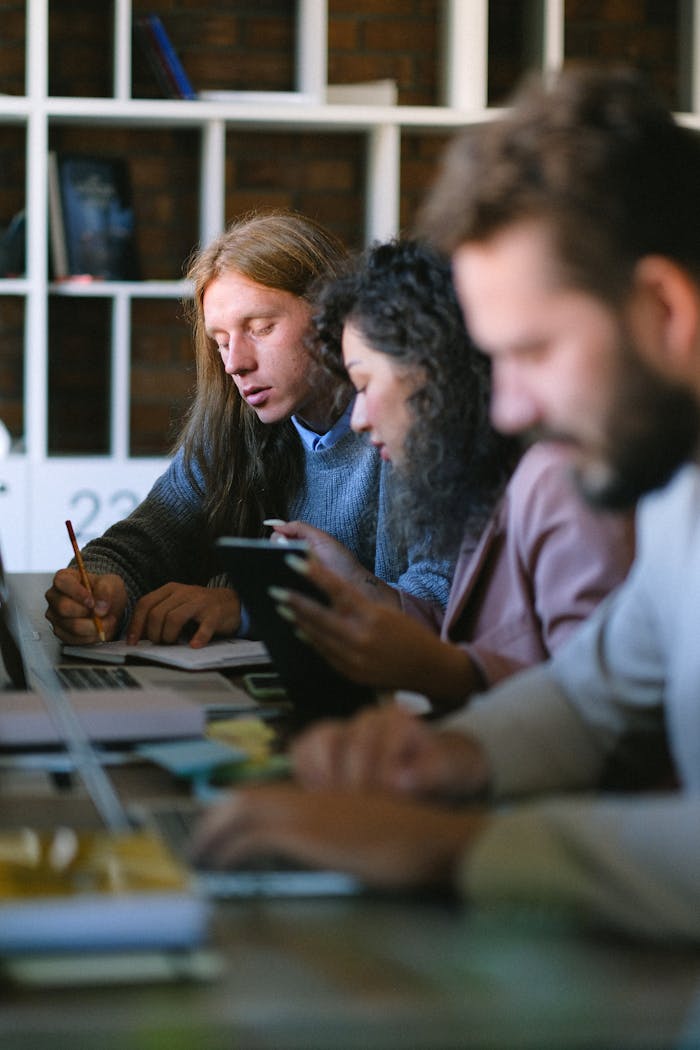 Focused professionals working collaboratively in a modern office setting.